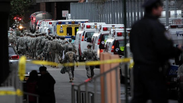 Military personnel help with the evacuation of Bellevue Hospital.
