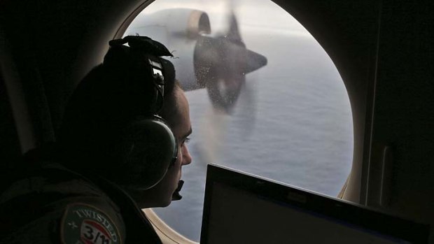 Flight officer Rayan Gharazeddine, on board an RAAF Orion, scans the ocean.