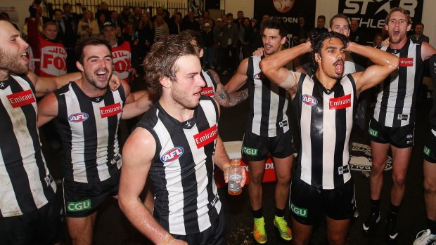 Tim Broomhead and Tony Armstrong of the Magpies are showered in Gatorade.