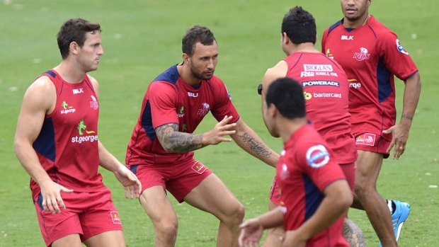 Quade Cooper prepares himself to tackle Anthony Faingaa during training.