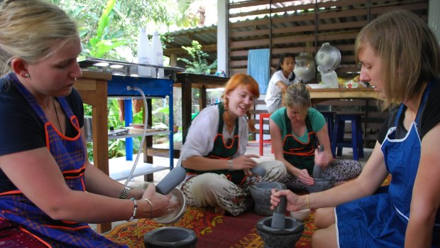 Tourists take part in a cooking class.