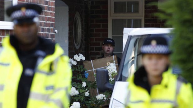 British police search the home of a family shot dead in their car in the French Alps in Claygate.