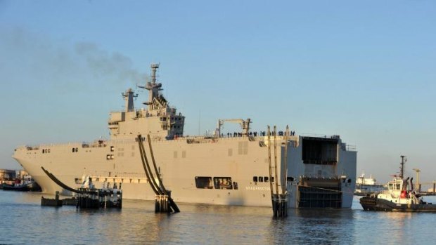 A Mistral class amphibious vessel leaves port for her first trial in western France.