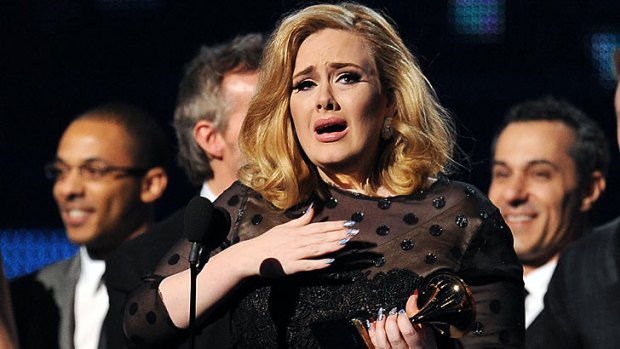 An emotional Adele accepts her Grammy for Album of the Year for <i>21</i>.
