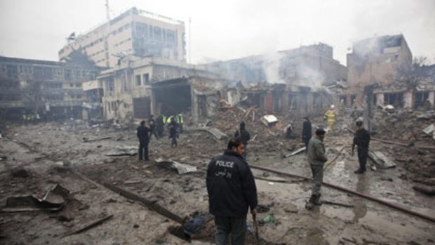 A policeman surveys some of the devastation of yesterday's suicide bomber attack.