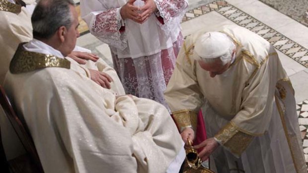 Pope Benedict XVI washes the foot of an unidentified layman in the Basilica of St John Lateran in Rome in a traditional Easter ceremony.
