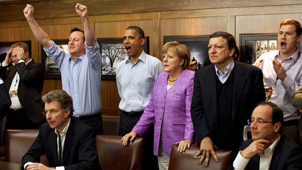 British PM David Cameron celebrates as G8 leaders watch English soccer club Chelsea win the European Champions League during a break at Camp David.