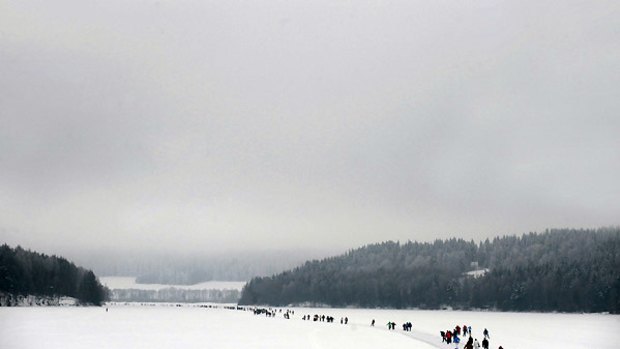 People walk on the 11km ice skating track at the frozen Lipno dam.