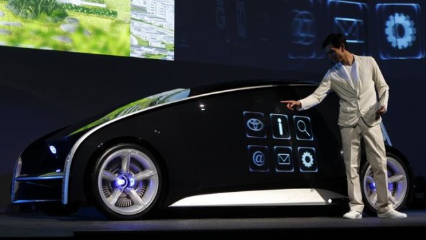 A model presents Toyota's concept vehicle Fun-Vii at a pre-Tokyo Motor show reception in a showroom in Tokyo November 28, 2011.