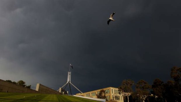 A storm brews over Parliament House in Canberra.