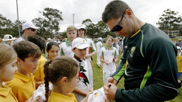 Michael Clarke signs autographs for children at the Kotara South Public School in Kotara, a suburb of Newcastle, on Monday.