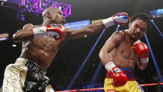 Pay day ... Floyd Mayweather Jr., left, hits Manny Pacquiao, during their welterweight title fight in Las Vegas. 