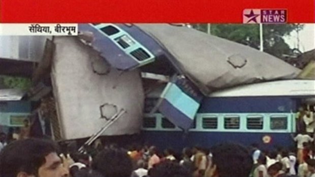 Crowds gather near crashed trains at Sainthia station, about 200 kilometers north of Kolkata.