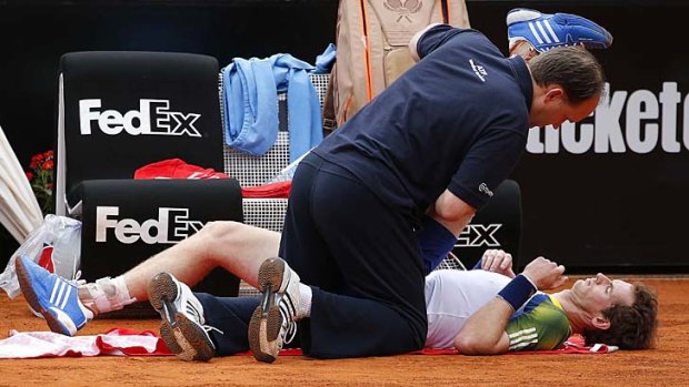 Andy Murray of Britain receives medical care during his match against Marcel Granollers of Spain at the Rome Masters.