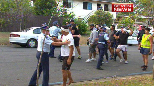 Police work to keep the rival groups apart.