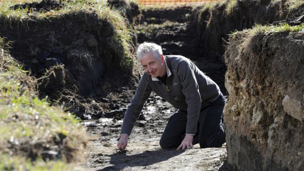 Dr. Tim Denham, convenor of the Master of Archeological Science
course at ANU, at a dig in the Jerrabomberra Wetlands where
remains of Army training trenches are being excavated. 