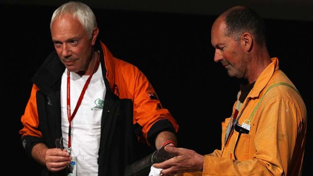 Christchurch Mayor Bob Parker, left, and rescue worker Anthony Wright hold up a time capsule.