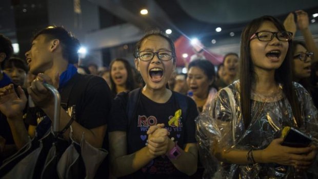 Student protesters chant pro-democracy slogans and continue to occupy the streets surrounding Hong Kong's financial district. 