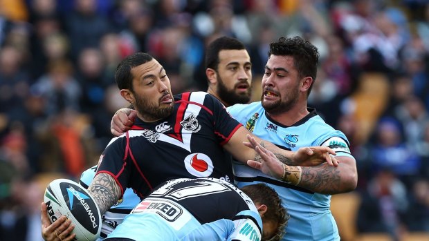 Shark attack: Feleti Mateo tries to get a pass away under all sorts of Cronulla pressure.