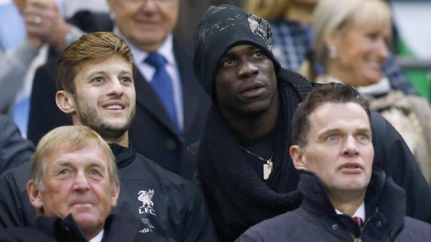Liverpool's new signings Mario Balotelli (R) and Adam Lallana (L) watch on during the loss to Manchester City earlier this week.