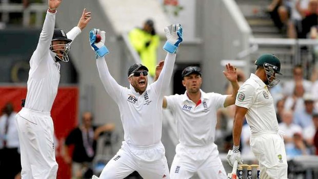 Howler: wicketkeeper Matt Prior celebrates with team mates Ian Bell (L) and Jonathan Trott after dismissing Usman Khawaja.