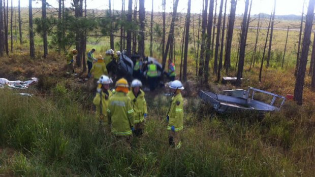 Emergency workers at the scene of a crash by the Bruce Highway on the Sunshine Coast.