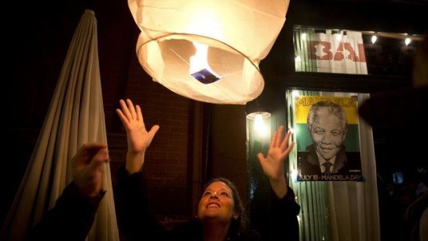 A woman releases a paper lantern outside Madiba, a restaurant named in honour of former South African president Nelson Mandela.