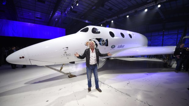 Sir Richard Branson poses in front of Virgin Galactic's SpaceShipTwo space tourism rocket after it was unveiled.