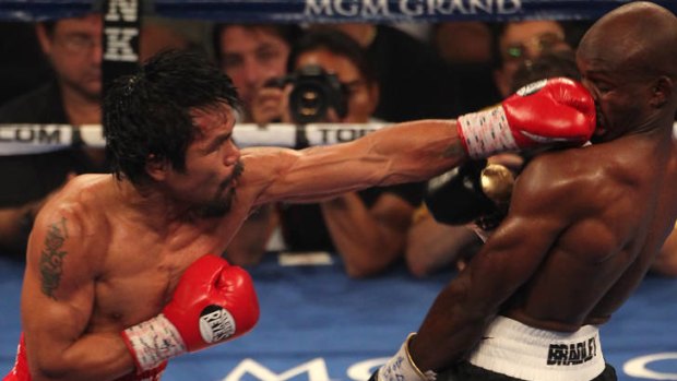 Manny Pacquiao lands a left to the head of Timothy Bradley.