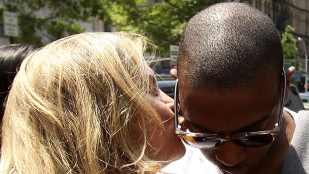 Heading to prison ... rapper Ja Rule gets a kiss from his lawyer Stacey Richman.