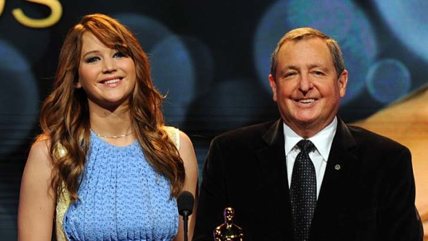 Actress Jennifer Lawrence and Academy of Motion Picture Arts and Sciences president Tom Sherak onstage during the 84th Academy Awards announcement in Los Angeles.