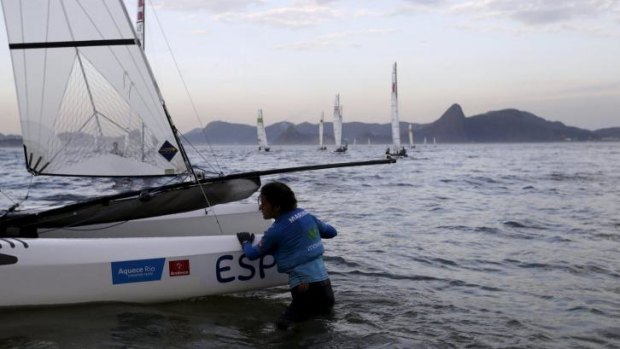 Murky waters: Spanish sailor Marina Lopez leaves Guanabara Bay after taking part in Nacra 17 class during the Aquece Rio International Regatta in Rio de Janeiro during the week. The regatta is a test event for the Rio 2016 Olympic Games. 