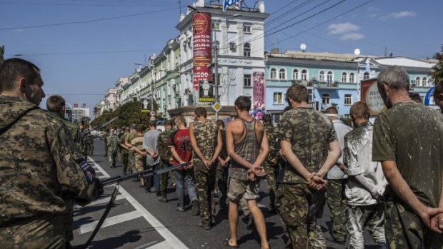 Armed pro-Russia separatists force Ukrainian prisoners of war to parade through the streets of Donetsk on Ukraine's Independence Day. 