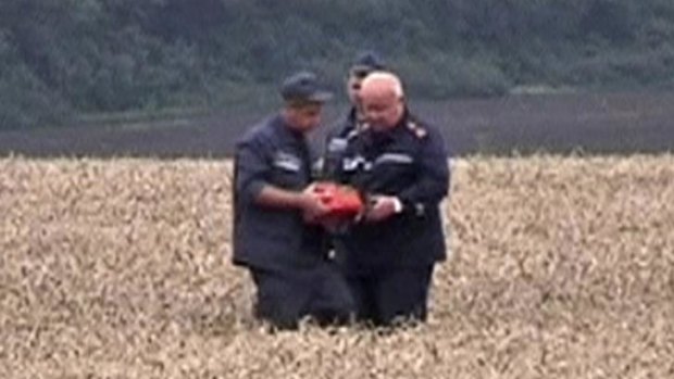 One of the first images of rescue workers discovering what is believed to be a black box flight recorder from MH17.  