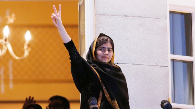Nobel Peace Prize laureate Malala Yousafzai flashes a victory sign from the balcony of the Grand Hotel in Oslo in December last year.