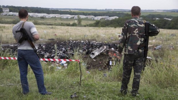 Pro-Russian fighters guard the site where MH17 came down in eastern Ukraine.