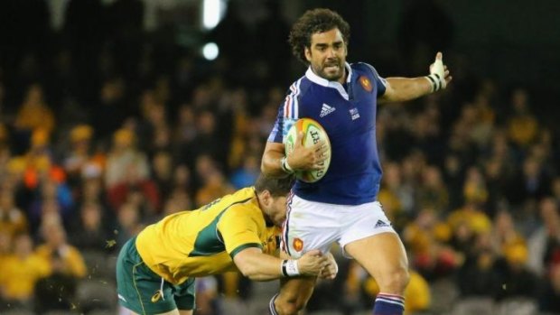 France's Yoann Huget is tackles during the 6-0 loss to the Wallabies.