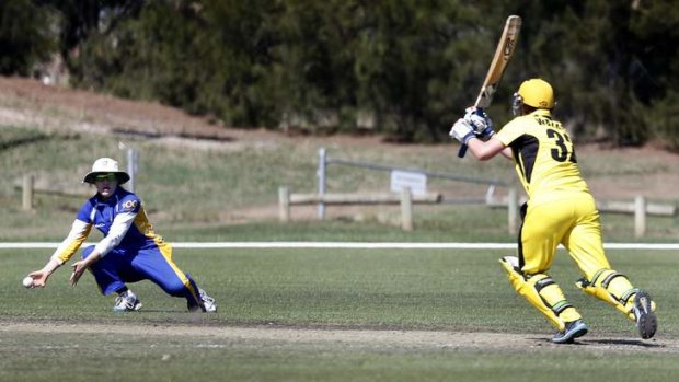 ACT fielder Sara Hungerford drops the ball off WA batter Jenny Wallace.