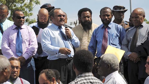 Peter O'Neill, centre, addresses supporters in Port Moresby as controversy over who is the legitimate prime minister continues.