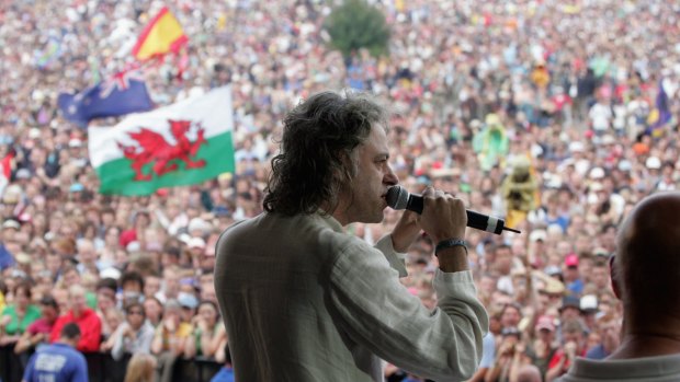 Bob Geldof, LIVE 8 organiser, invites the festival crowd to link hands in support of the Make Poverty History campaign, on the second day of the Glastonbury Music Festival in 2005.