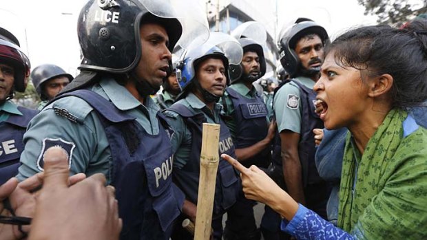 Angry populace: An activist argues with police in Bangladesh's capital, Dhaka, last week.