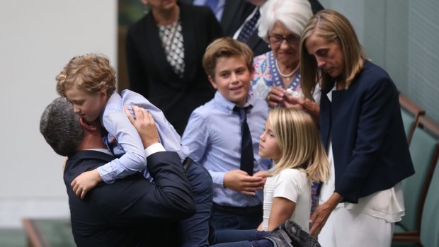 Former Treasurer Joe Hockey embraces his youngest son Iggy after his valedictory speech at Parliament House in Canberra on Wednesday 21 October 2015. Photo: Andrew Meares