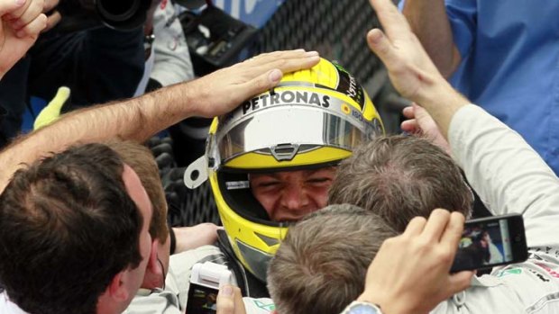 Lucky race 111 &#8230; Nico Rosberg celebrates his first formula one win with Mercedes team members in Shanghai.