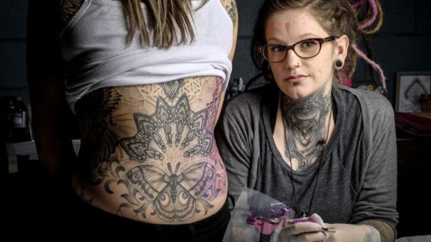 Tattooist Stacey Molly of Liquid Silver tattoo parlour and her client Sarah.