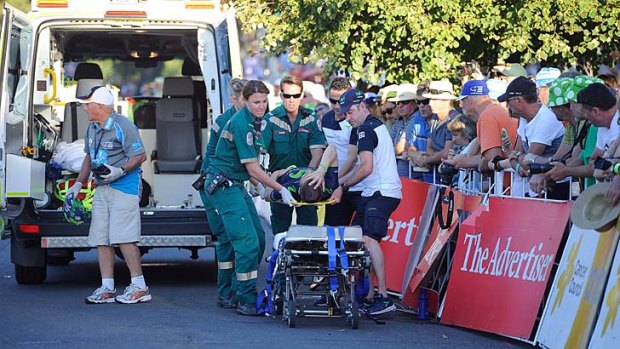 Giovanni Visconti is carried into an ambulance after crashing during day one of the Tour Down Under on Sunday.