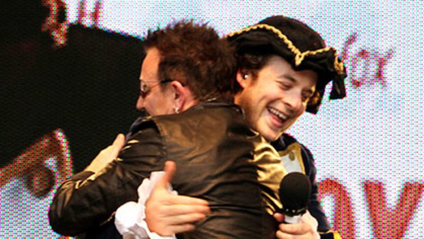 Hamish Blake receives a hug from Bono.