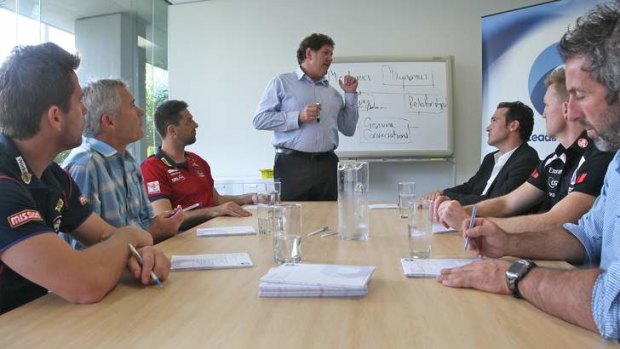 Talk time: Ray McLean from Leading Teams conducts a session with, seated from left, Shannon Grant (Western Bulldogs assistant coach),  Mick Poulton (AFL Coaches Association), Jade Rawlings (Melbourne assistant coach), Adrian Anderson (former AFL football operations manager), Nathan Buckley (Collingwood) and Justin Peckett (former St Kilda player, now a Leading Teams facilitator).