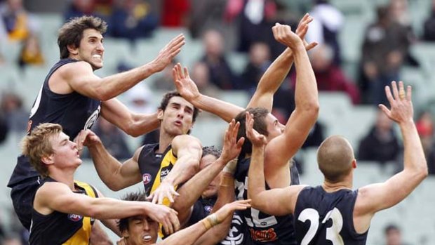 Carlton's Jarrad Waite soars above a pack of players.