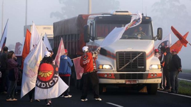 Members of labor unions block a main highway on the National Day of Struggle, in Porto Alegre.