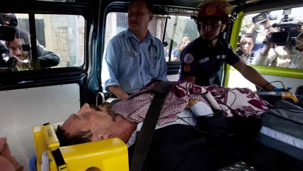 John McAfee lies inside an ambulance on his way to a hospital in Guatemala City.